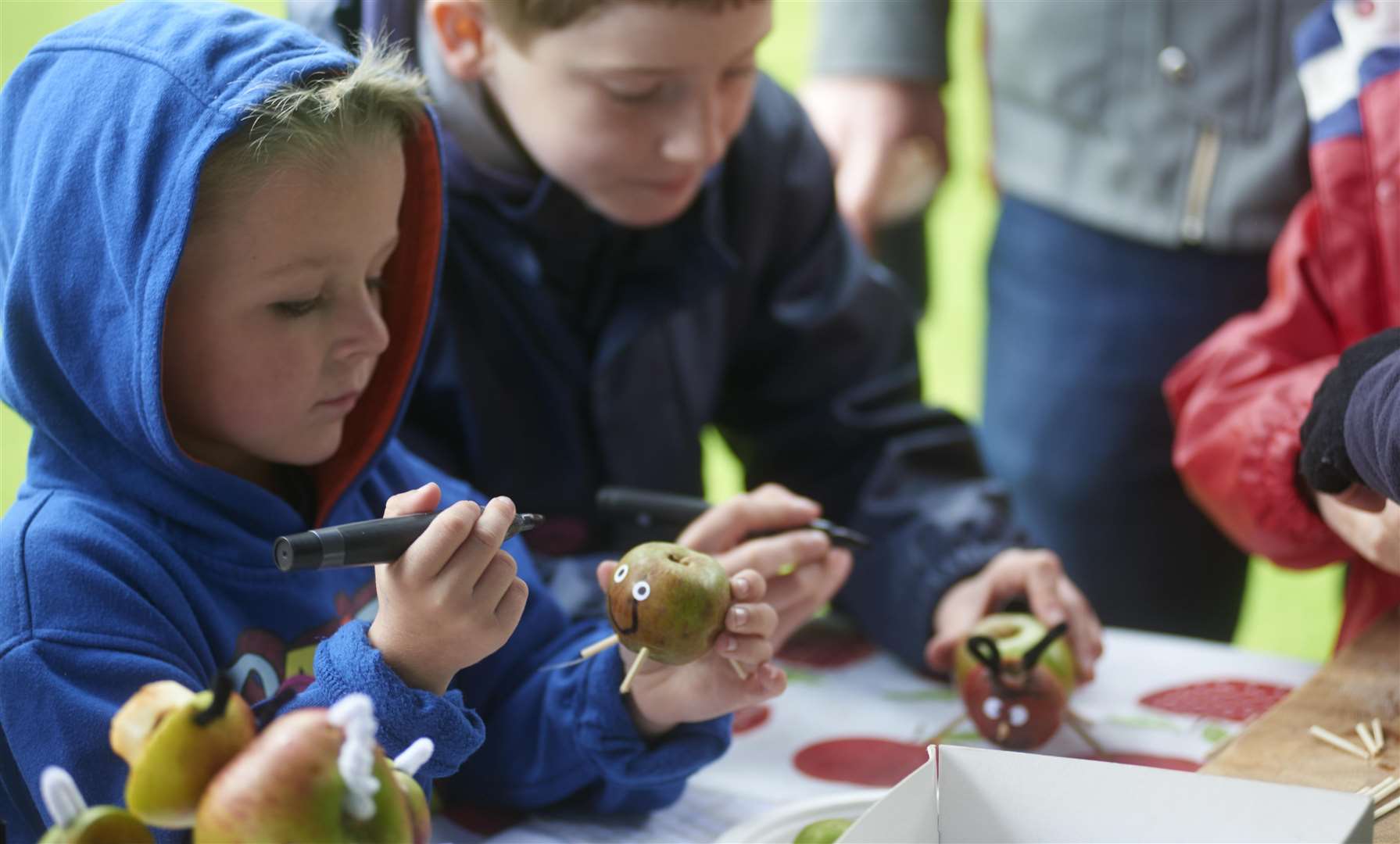 Children enjoying apple themed crafts on Apple Day