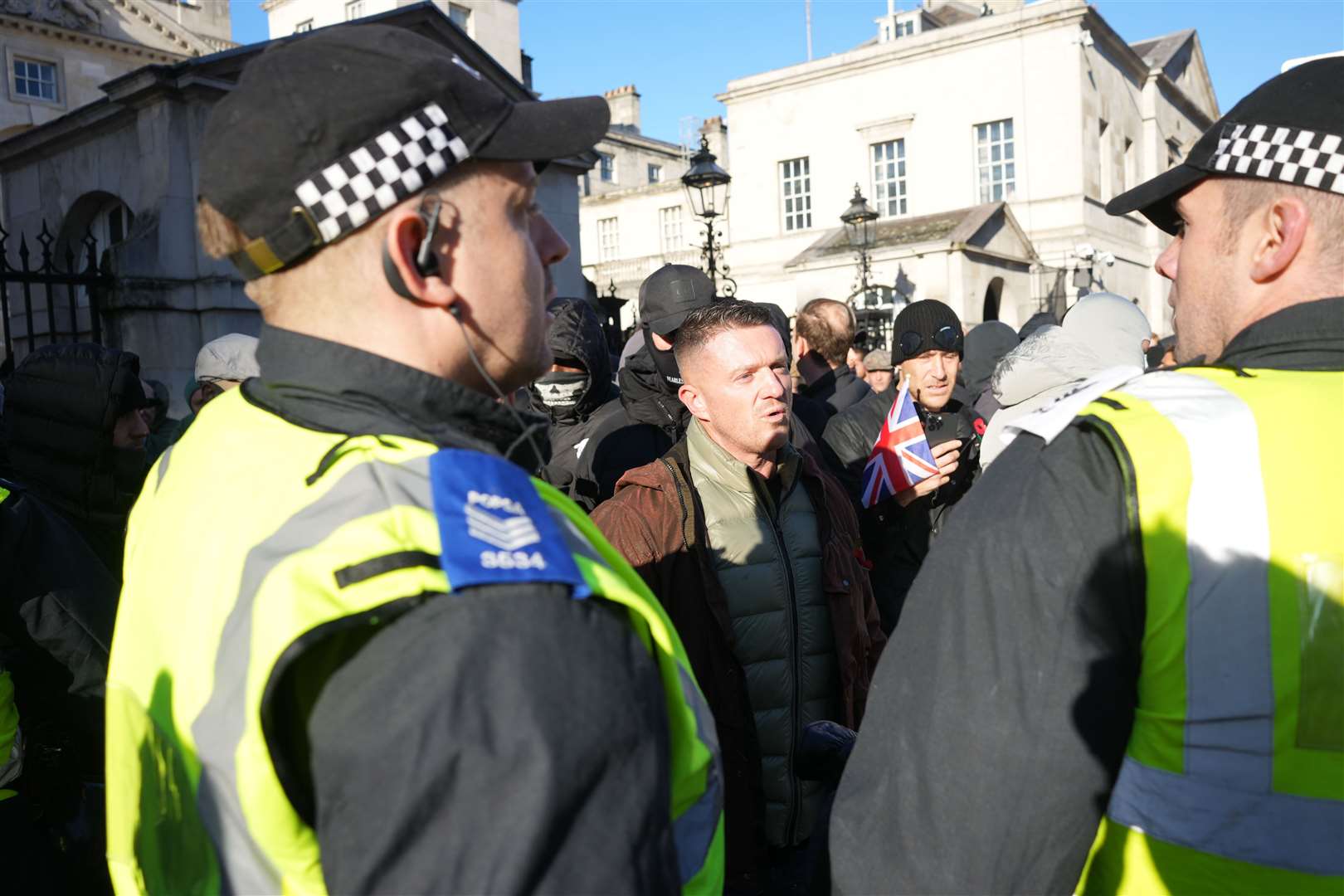 Tommy Robinson speaks to police officers as he arrives at the Cenotaph in Whitehall, central London, ahead of a pro-Palestinian protest march which is taking place from Hyde Park to the US embassy in Vauxhall (Jeff Moore/PA)