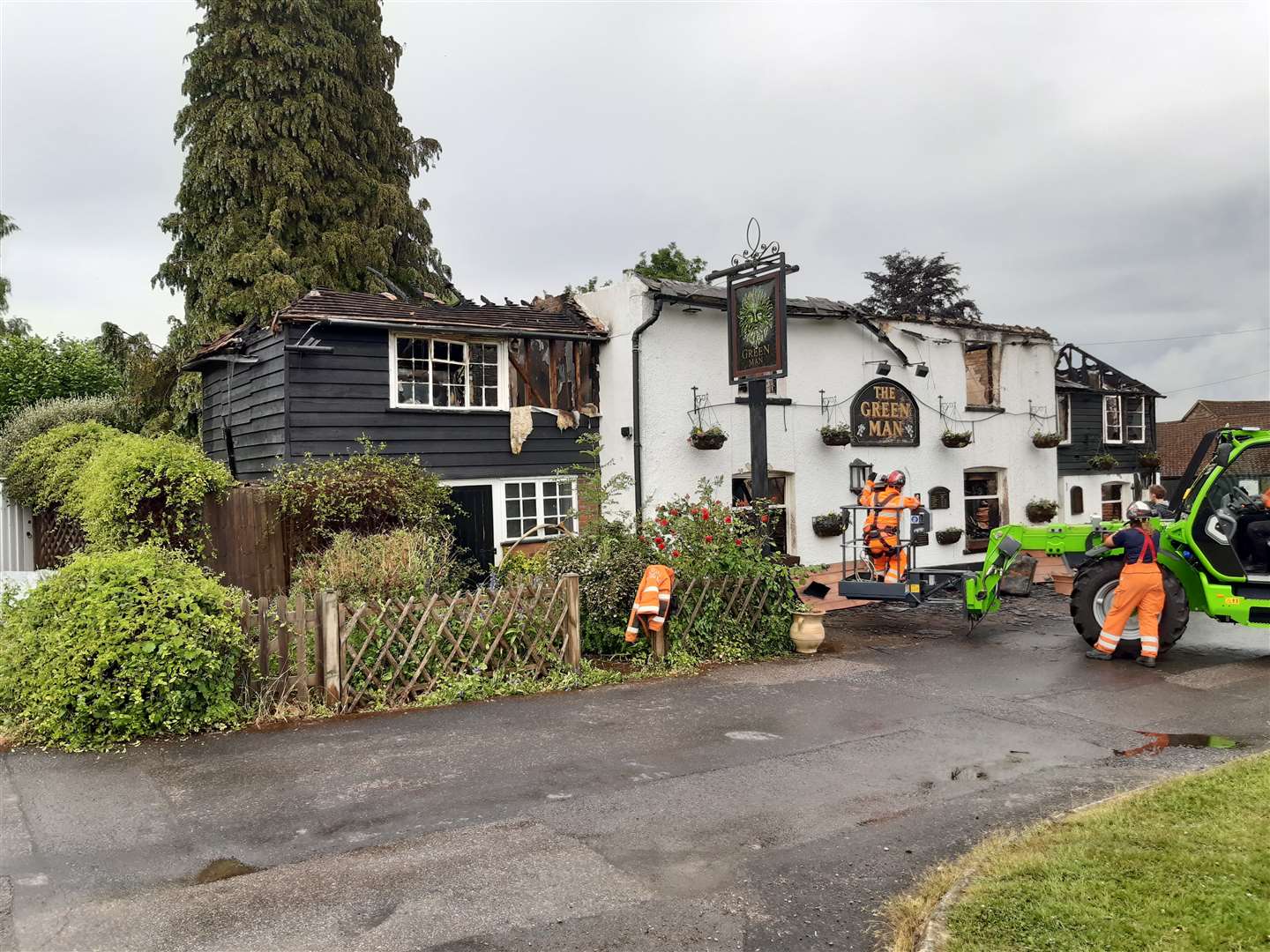 Fire and recovery crews work to make the pub safe