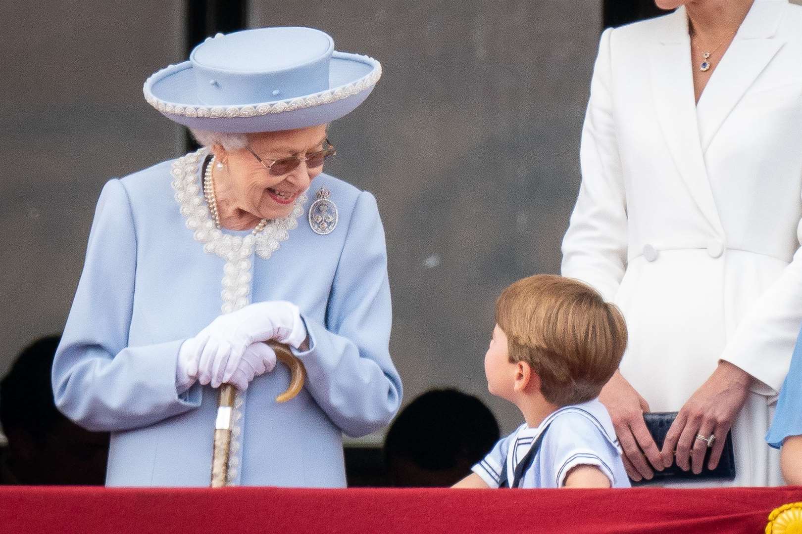 The Queen speaks to Prince Louis on the balcony of Buckingham Palace as they watch the Platinum Jubilee flypast (Aaron Chown/PA)