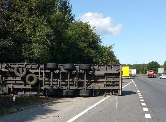 The lorry has overturned just off the carriageway. Picture: Kent Police RPU