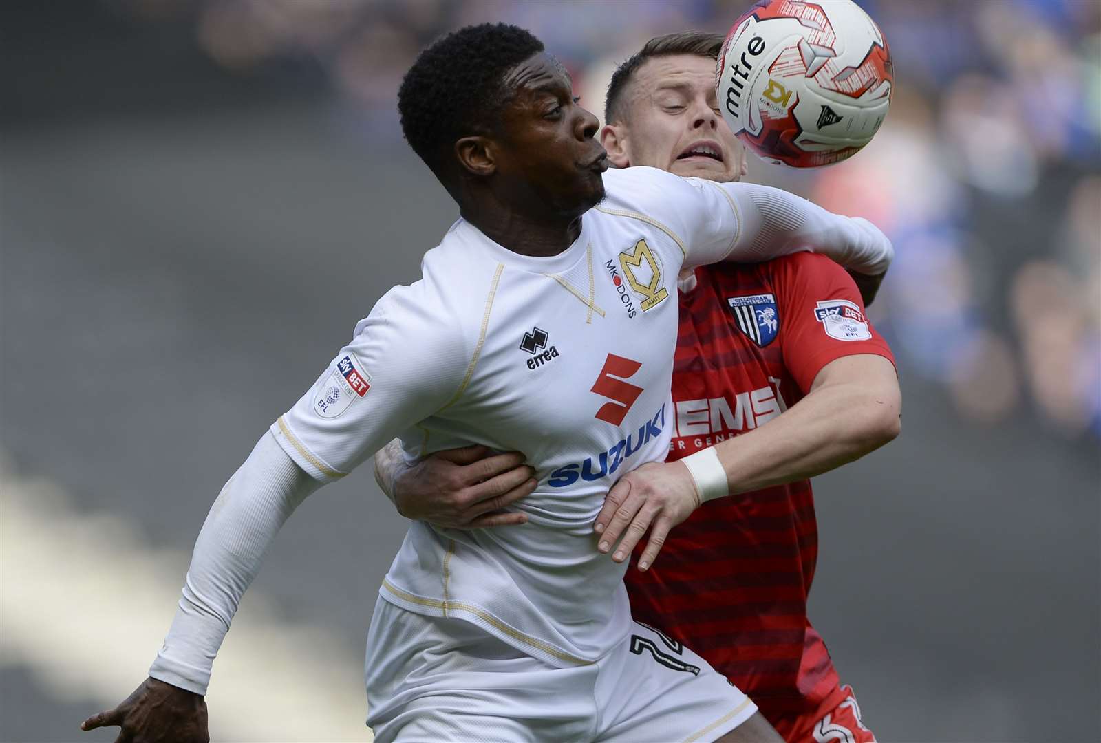 Gillingham’s Mark Byrne loses out to Kieran Agard during their game with MK Dons in 2017