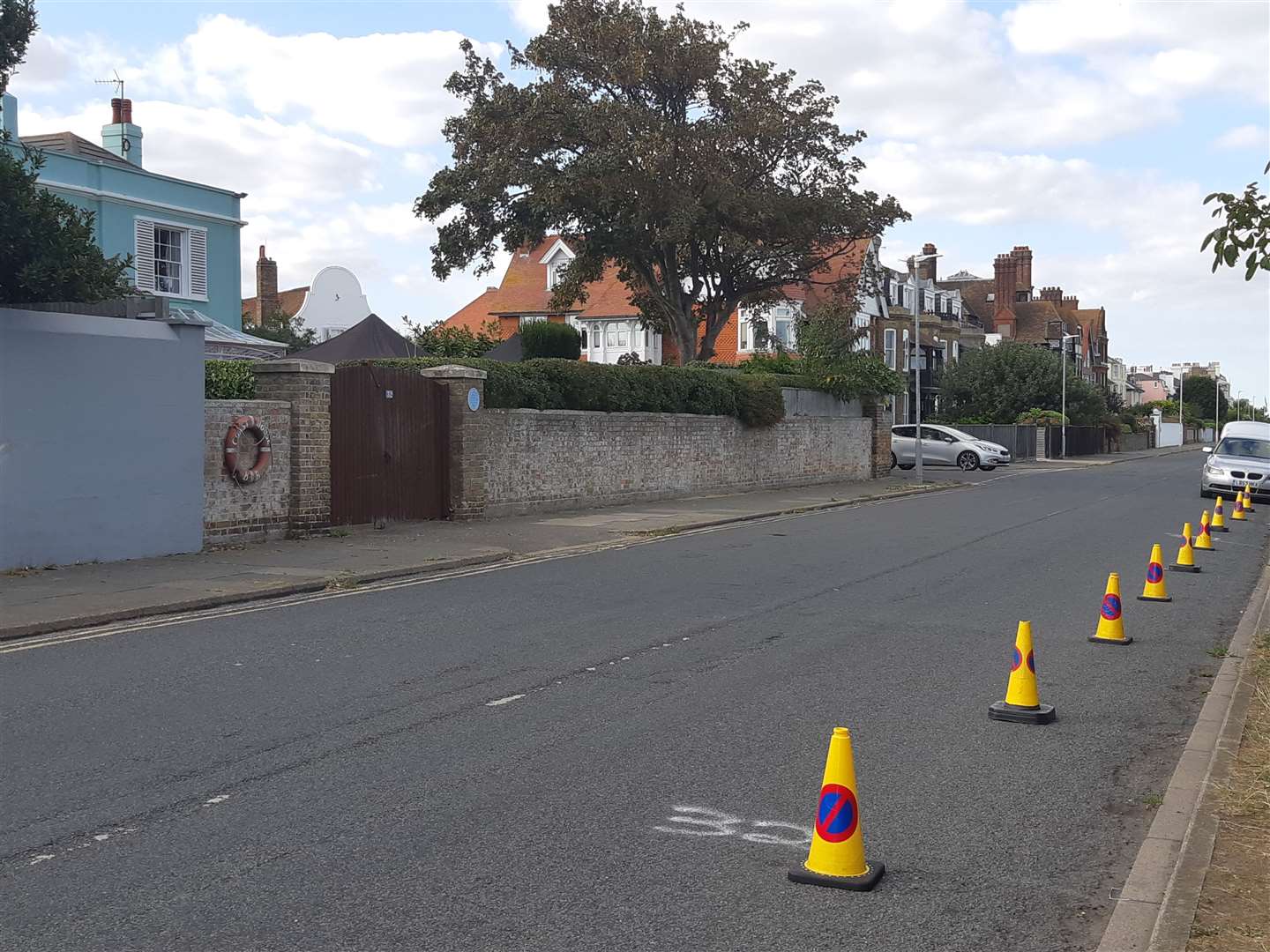 Yellow cones restrict parking outside the house believed to have been hired by film producers