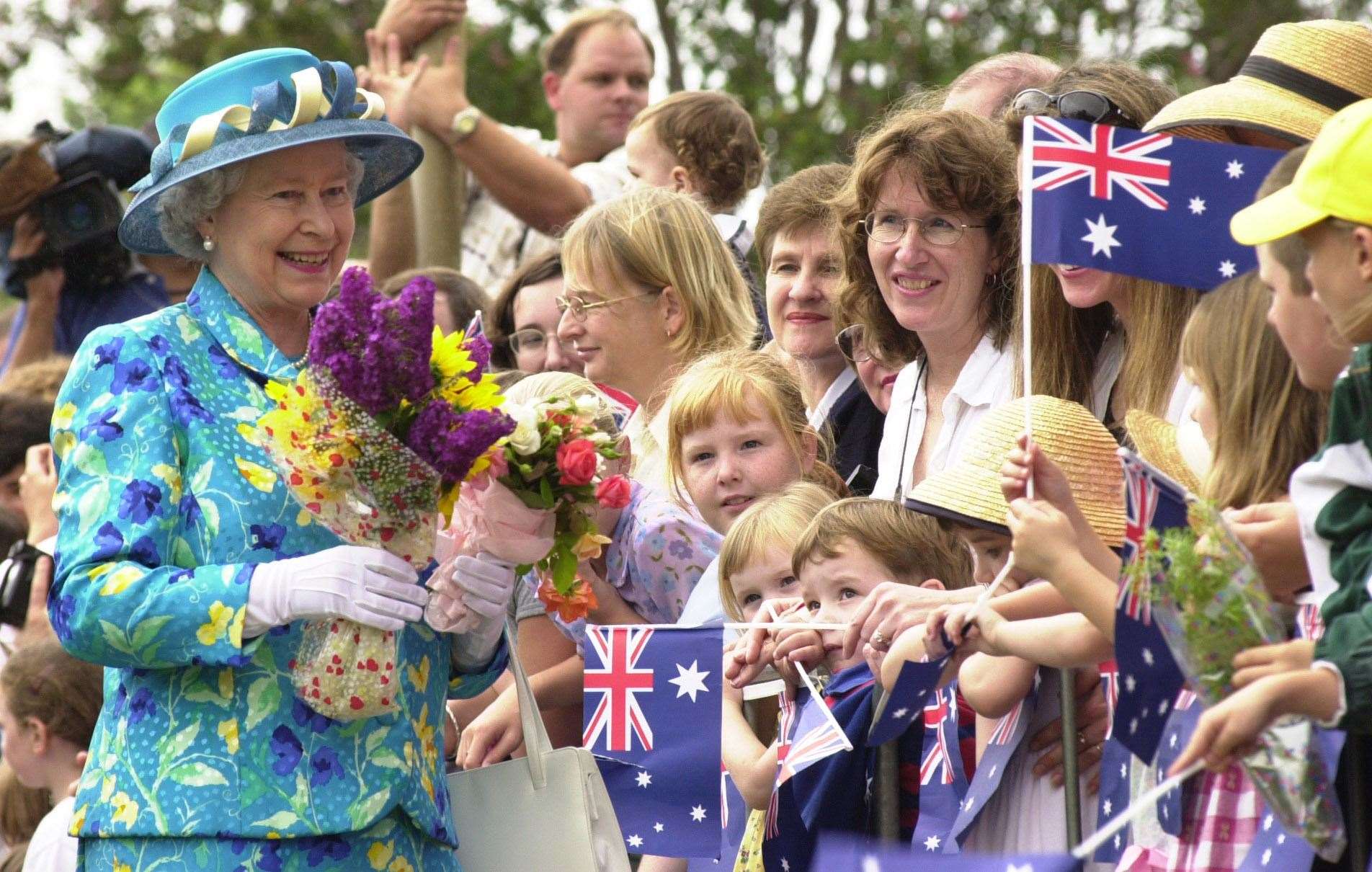 The Queen receives flowers in Central Park, Bourke, Australia, in 2000 (Fiona Hanson/PA)