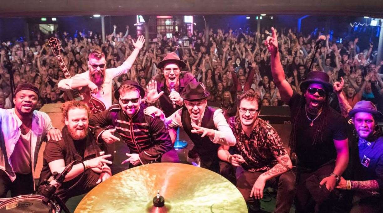 The Dualers with founder Tyber Cranstoun (centre holding microphone)