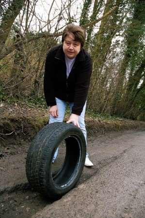 Claire Ansell with the pot hole in Doddington which punctured her tyre