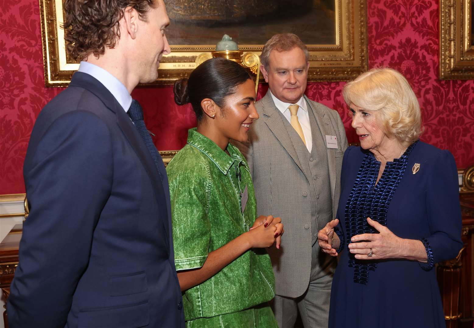 Queen Camilla speaks to Tom Hiddleston, Olivia Dean and Hugh Bonneville during a Palace reception for the BBC’s 500 Words competition (Chris Jackson/PA)