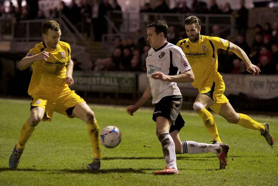 Danny Harris takes on two Woking defenders (Pic: Andy Payton)