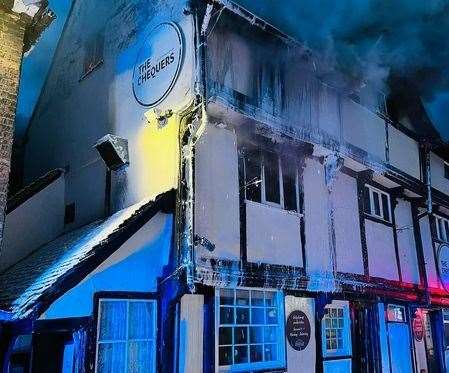 The Chequers pub on fire