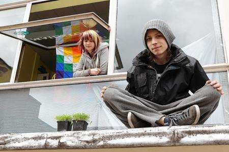 Jamie Rawlings, 17 sits next to cress he has grown, on the canopy over the main entrance of Maidstone's former library