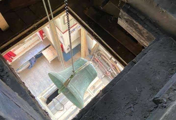 One of the huge bells being gently lowered down from the tower