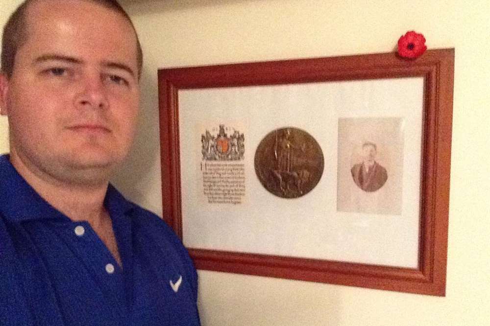 Andrew Bratley beside a memorial to his great, great uncle killed in the first year of the Great War