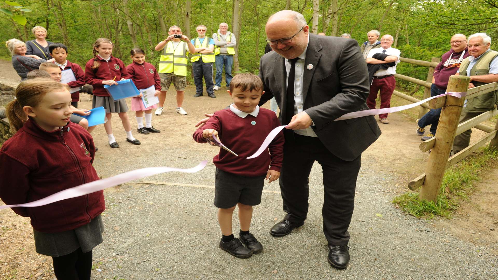 Amber, 10, and Joshua, eight, help council leader Cllr Jeremy Kite officially open the refurbished walkway. Picture: Steve Crispe