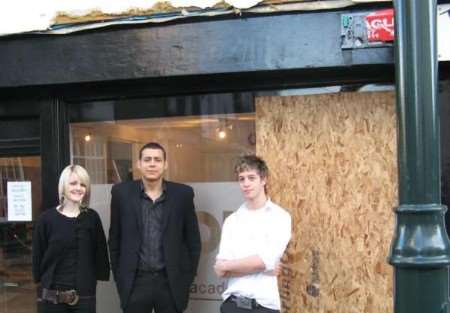 Staff members Sarah Smisson, manager Marcus George and Tobias Clapp outside the damaged premises