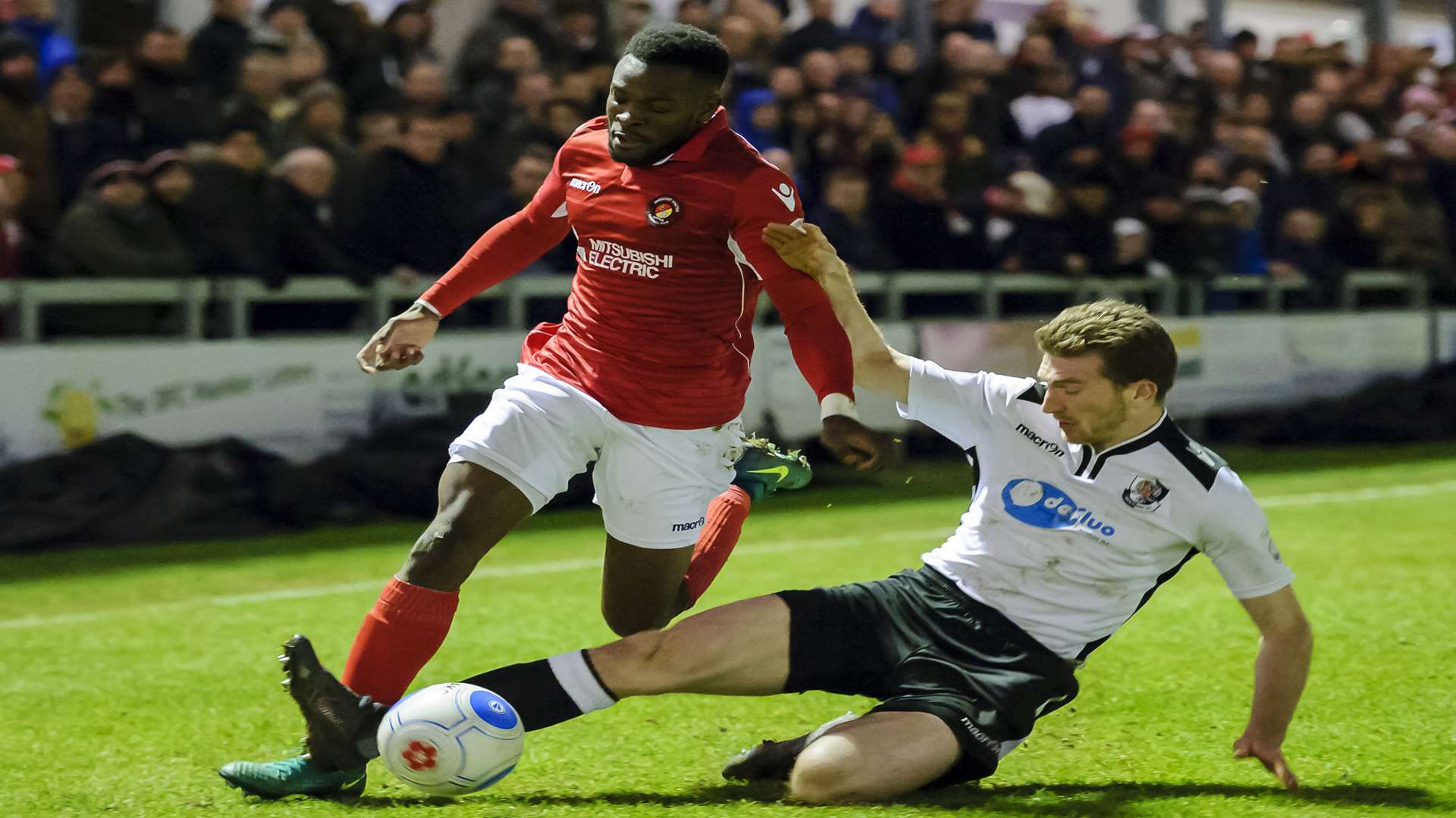 Darts defender Ronnie Vint slides in against Ebbsfleet's Anthony Cook. Picture: Andy Payton