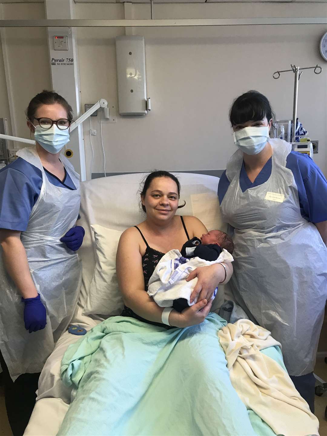 Joanna Szymanska-Rusta with baby Liam and staff from William Harvey Hospital's maternity unit