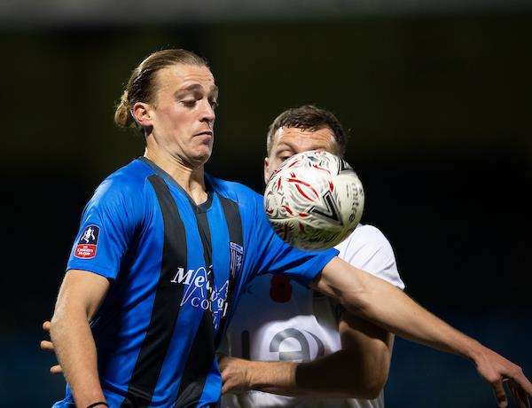 Gills striker Tom Eaves fends off a challenge Picture: Ady Kerry