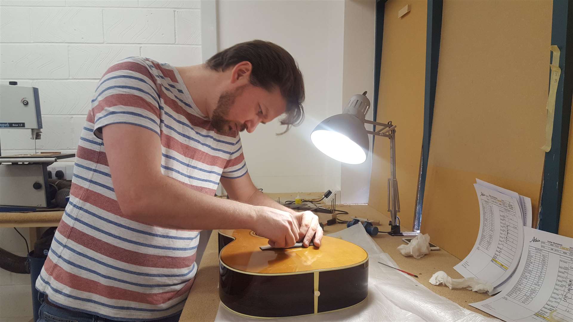 Guitar builder Laurence Lock works on an Atkin