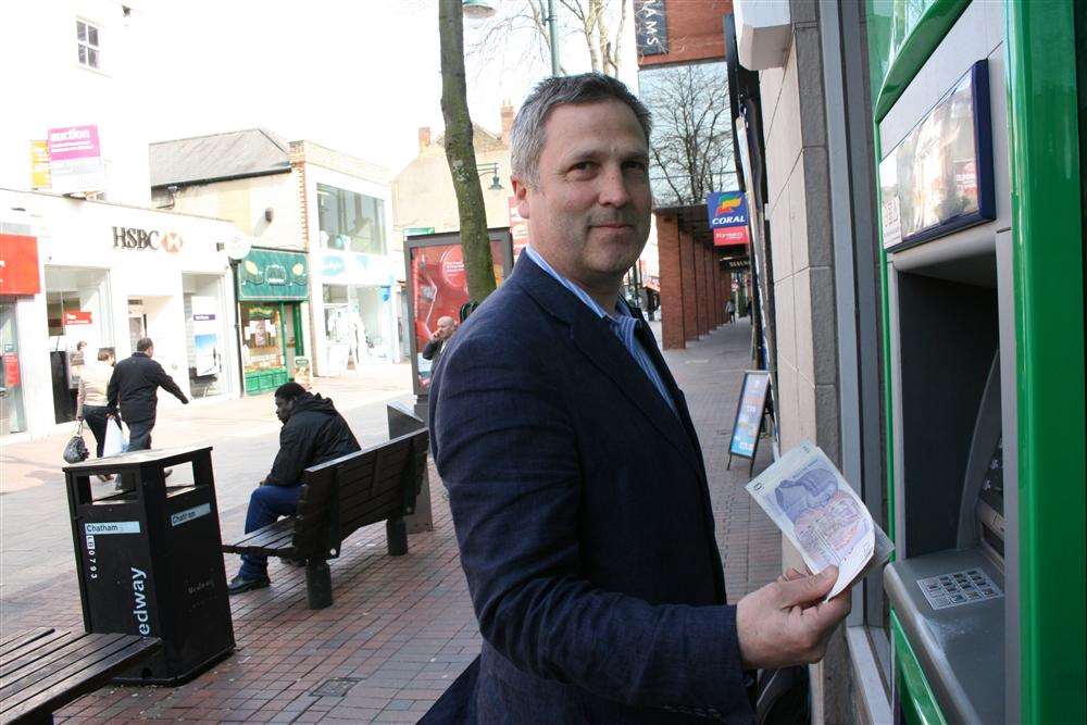 Cllr Turpin draws out £100 from the cashpoint