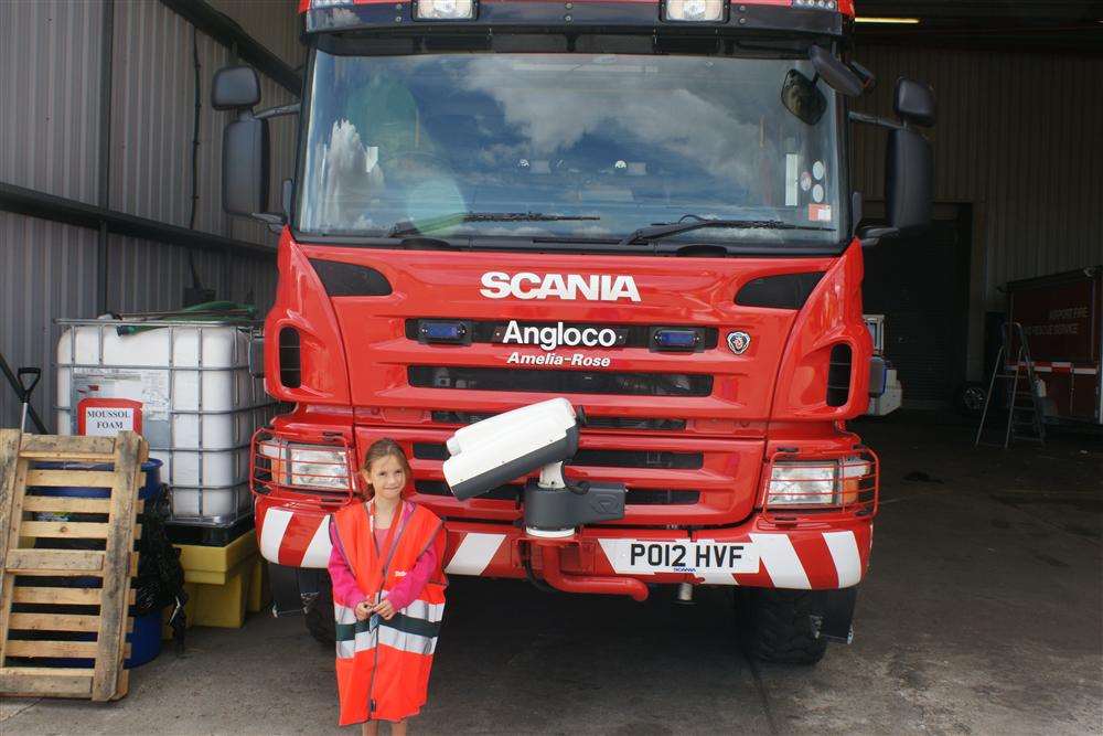 Amelia-Rose Lucas standing next to the fire truck named after her