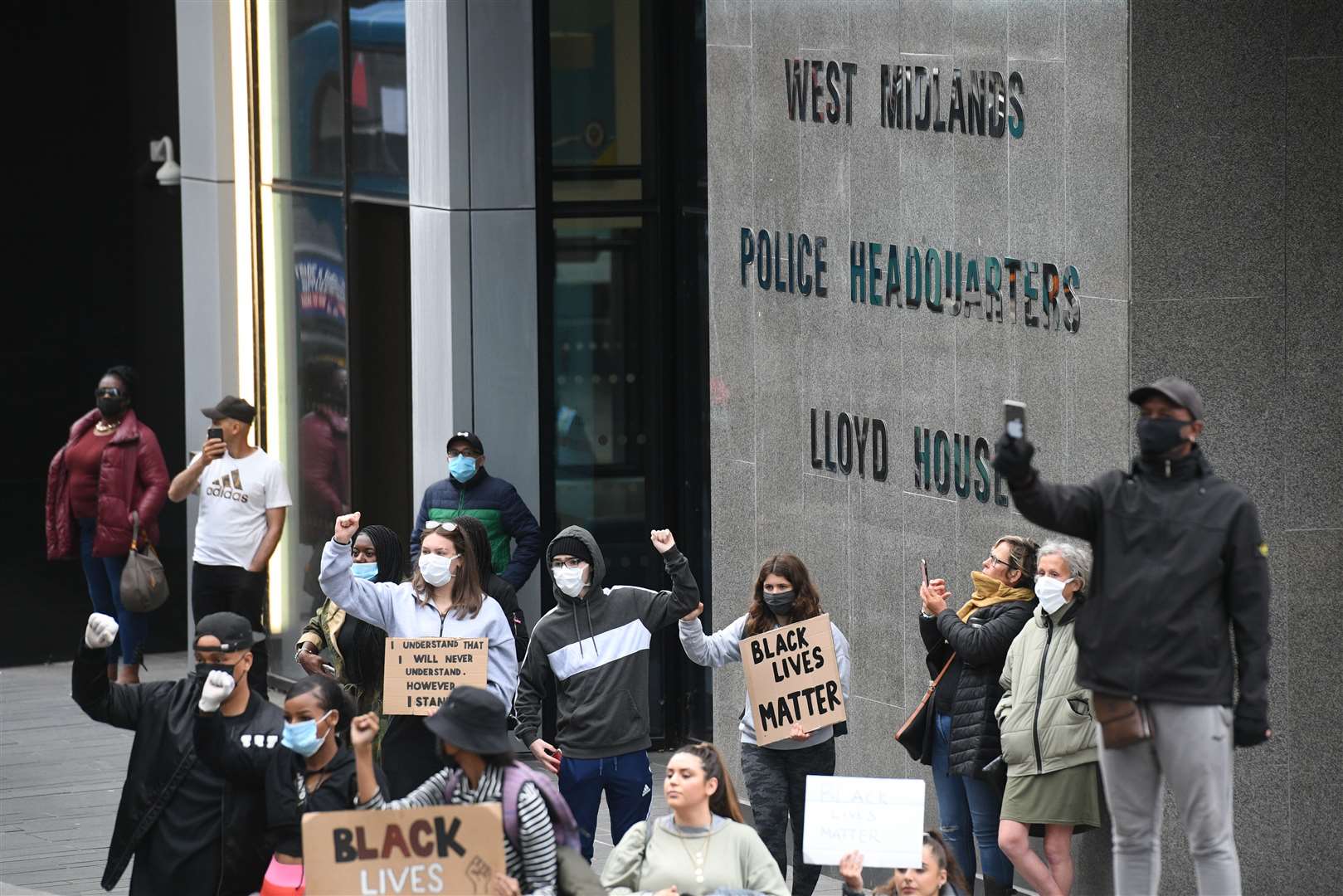People gather outside the West Midlands Police headquarters during a Black Lives Matter protest rally in Birmingham (Joe Giddens/PA)