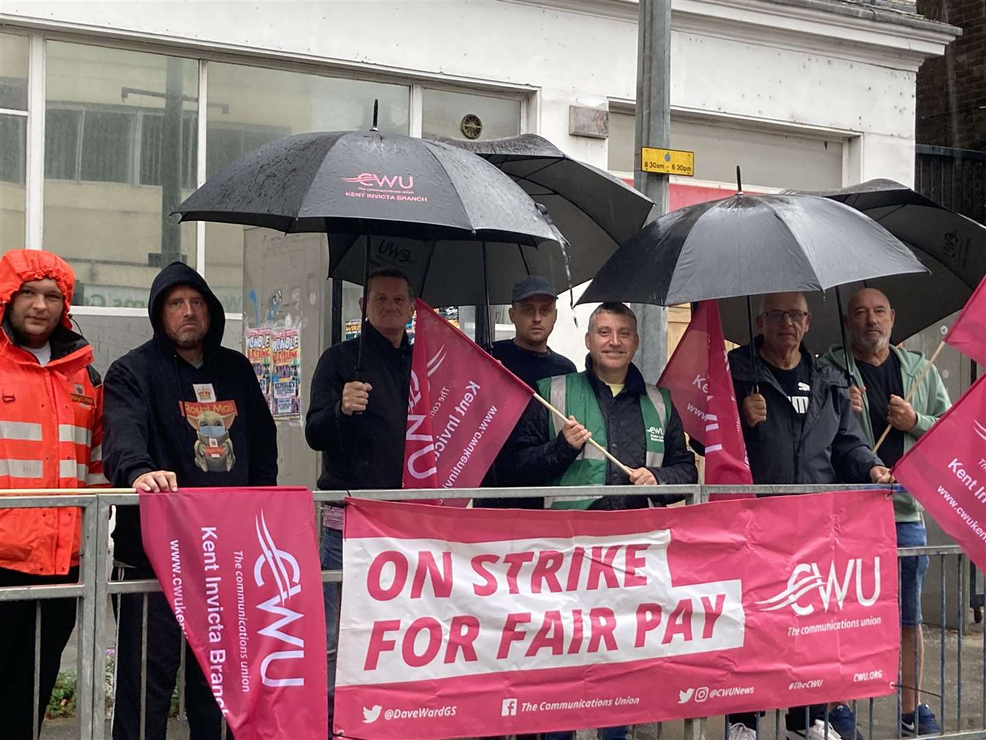 Communication Workers Union pickets striking in the rain outside the Royal Mail's depot in Sheerness Broadway