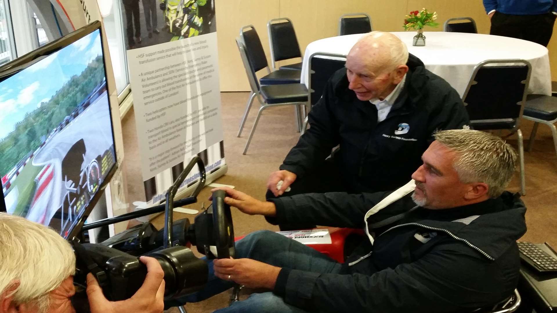 Paul tries out the circuit simulator at Buckmore Park watched by John Surtees. Picture: Clare Freeman.