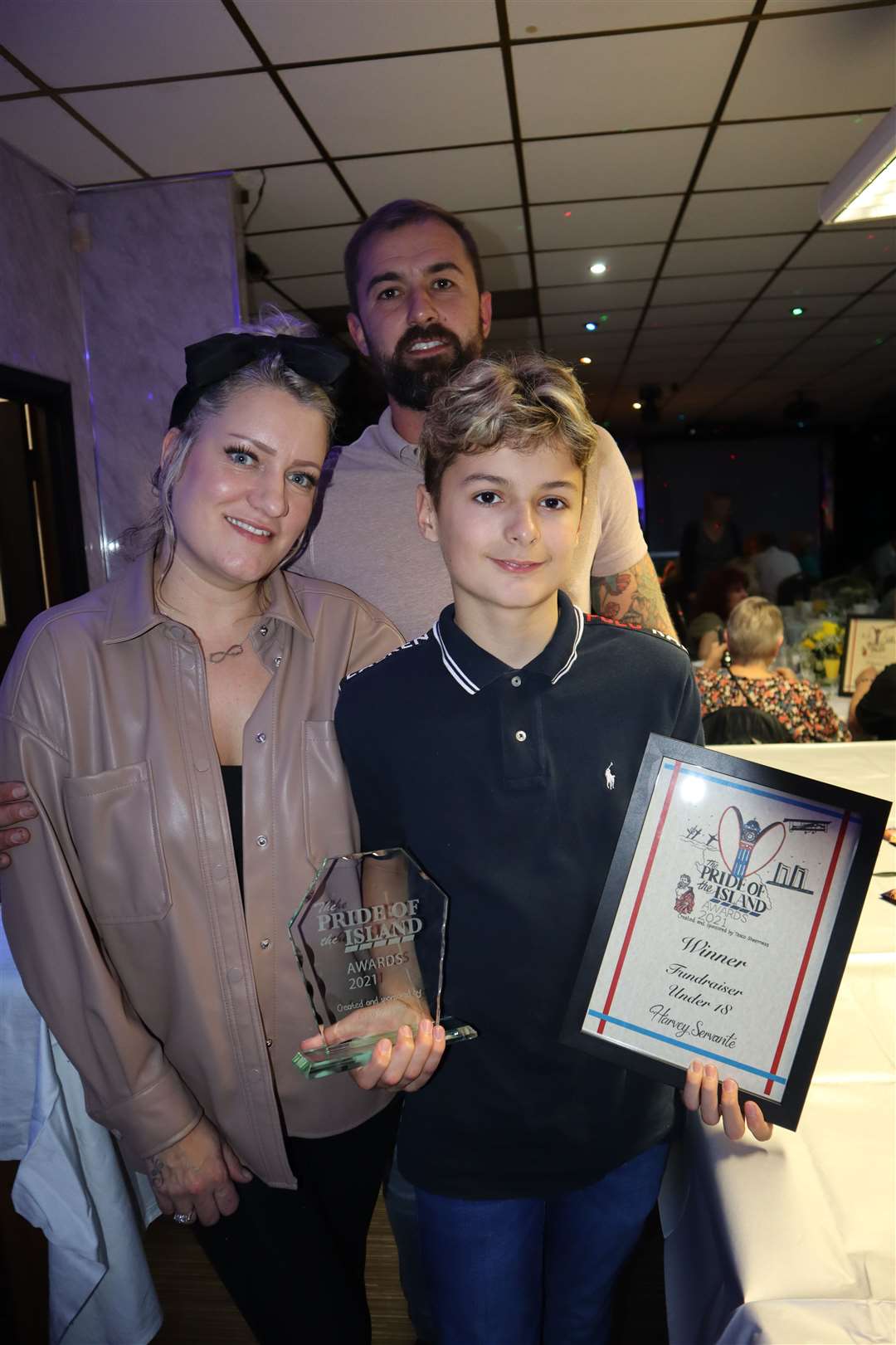 Harvey Servante, 12, pictured with his mum Gemma and dad Daniel, was named under-18 fundraiser of the year with Joshua Jarvis in the Tesco Pride of the Island awards