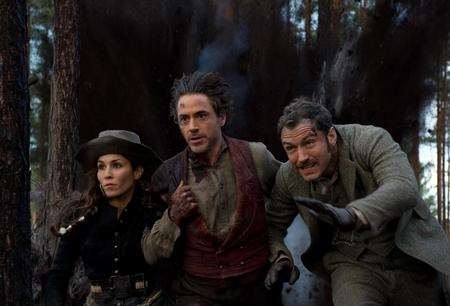 Noomi Rapace as Madam Simza Heron, Robert Downey Jr as Sherlock Holmes and Jude Law as Dr. James Watson in Sherlock Holmes: A Game of Shadows. Picture: PA Photo/Warner Bros. Pictures.