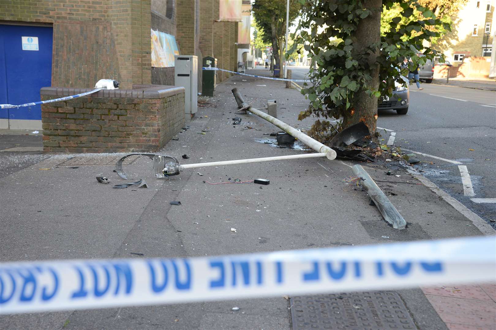 A small fuel spillage can be seen, along with damage to the tree and a lamppost smashed on the floor