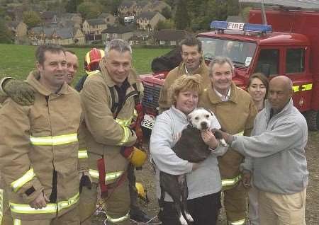 HAPPY REUNION: Angela Schoeffer with Rizla and some of the firefighters involved in the rescue. Picture: JOHN WARDLEY