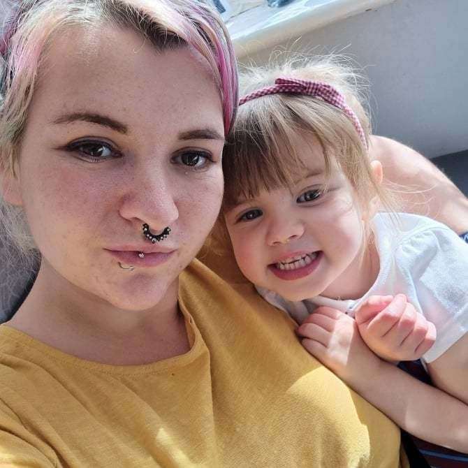 Margate resident Stacie Goddard with her daughter Aurora, whose therapy cat was killed by two rampaging huskies. Picture: Stacie Goddard