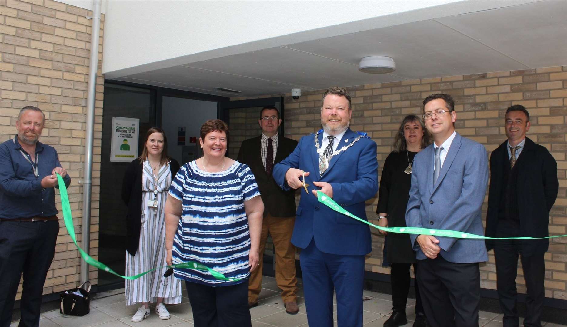 Mayor of Ashford, Cllr Callum Knowles joins Cllr Bill Barrett (far right), head of housing Sharon Williams (fourth left) and other officers outside the town centre development at its official opening in the summer