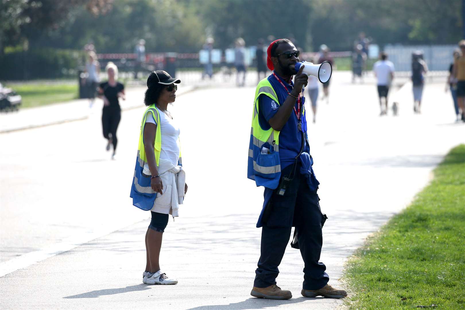 Wardens use a megaphone to issue advice at Victoria Park, east London (Jonathan Brady/PA)
