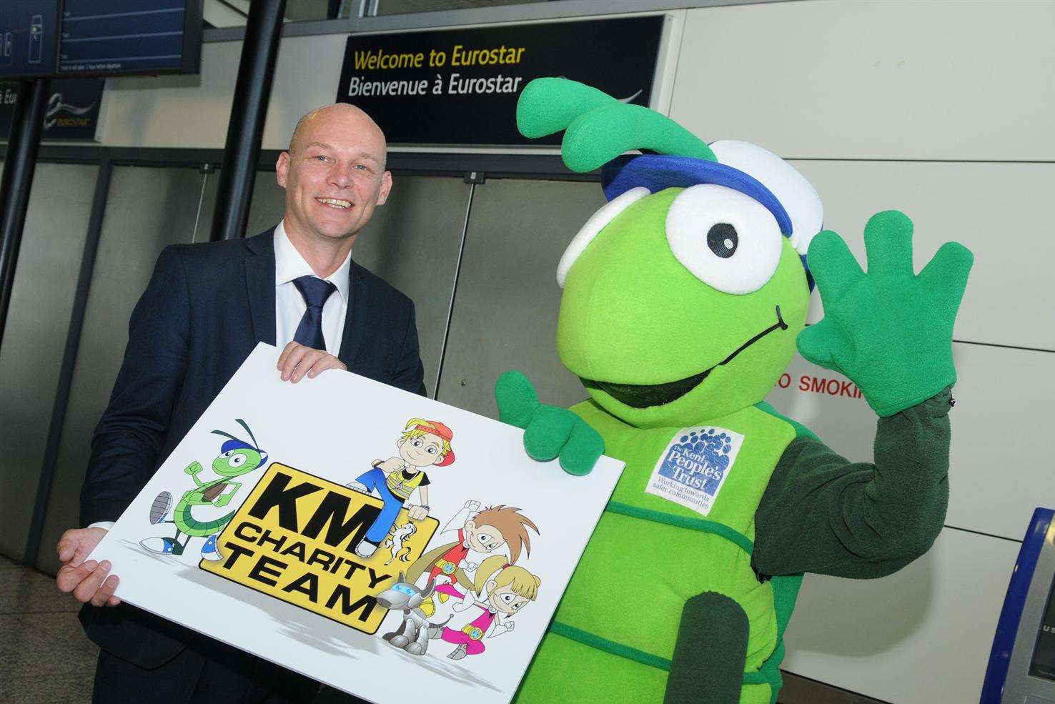 Eurostar's head of environment and energy, Luke Ervine, celebrates the company's support of KM Walk to School 2015 with the scheme's mascot Buster Bug