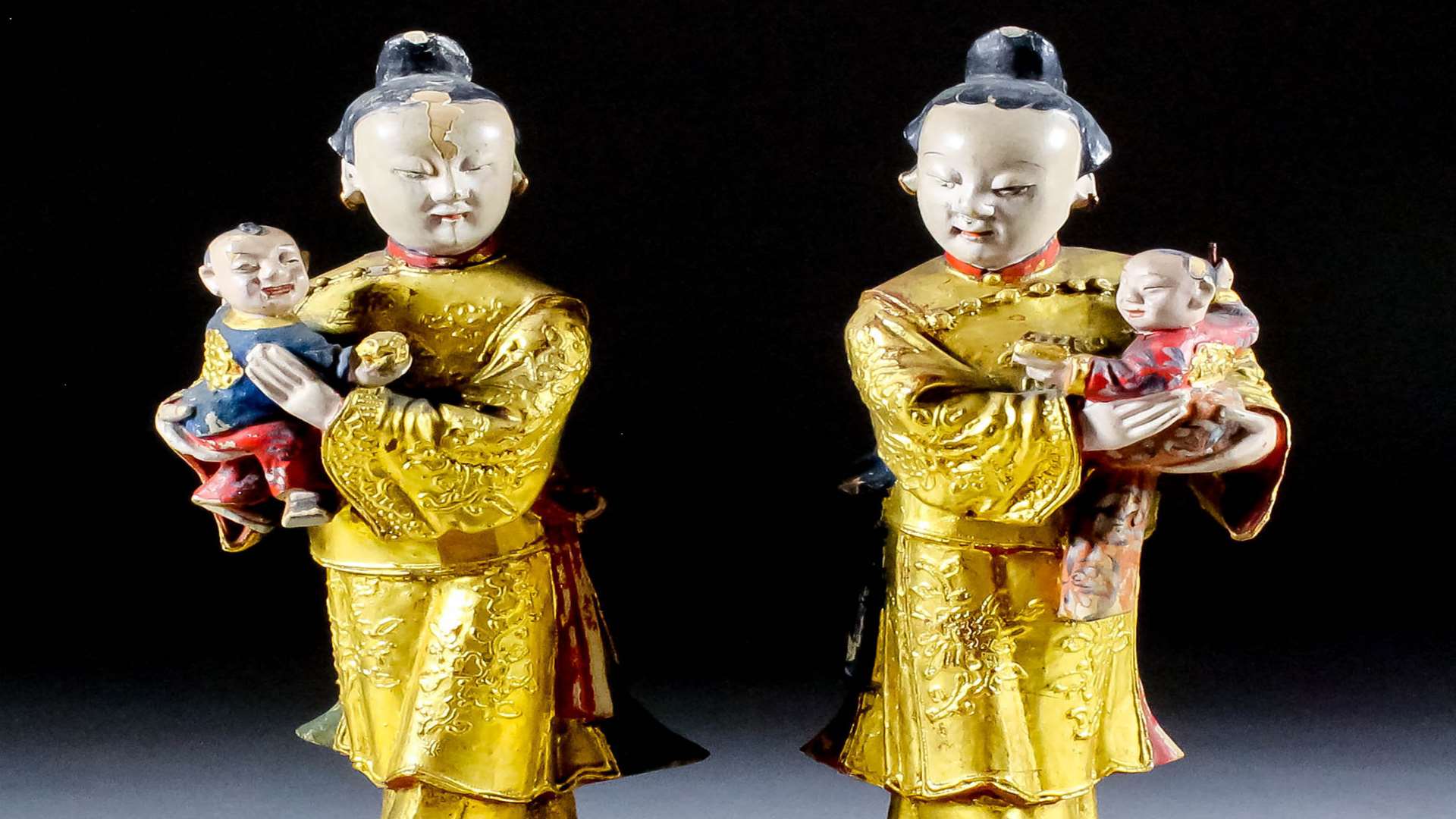 A pair of Chinese carved polychrome and giltwood standing figures