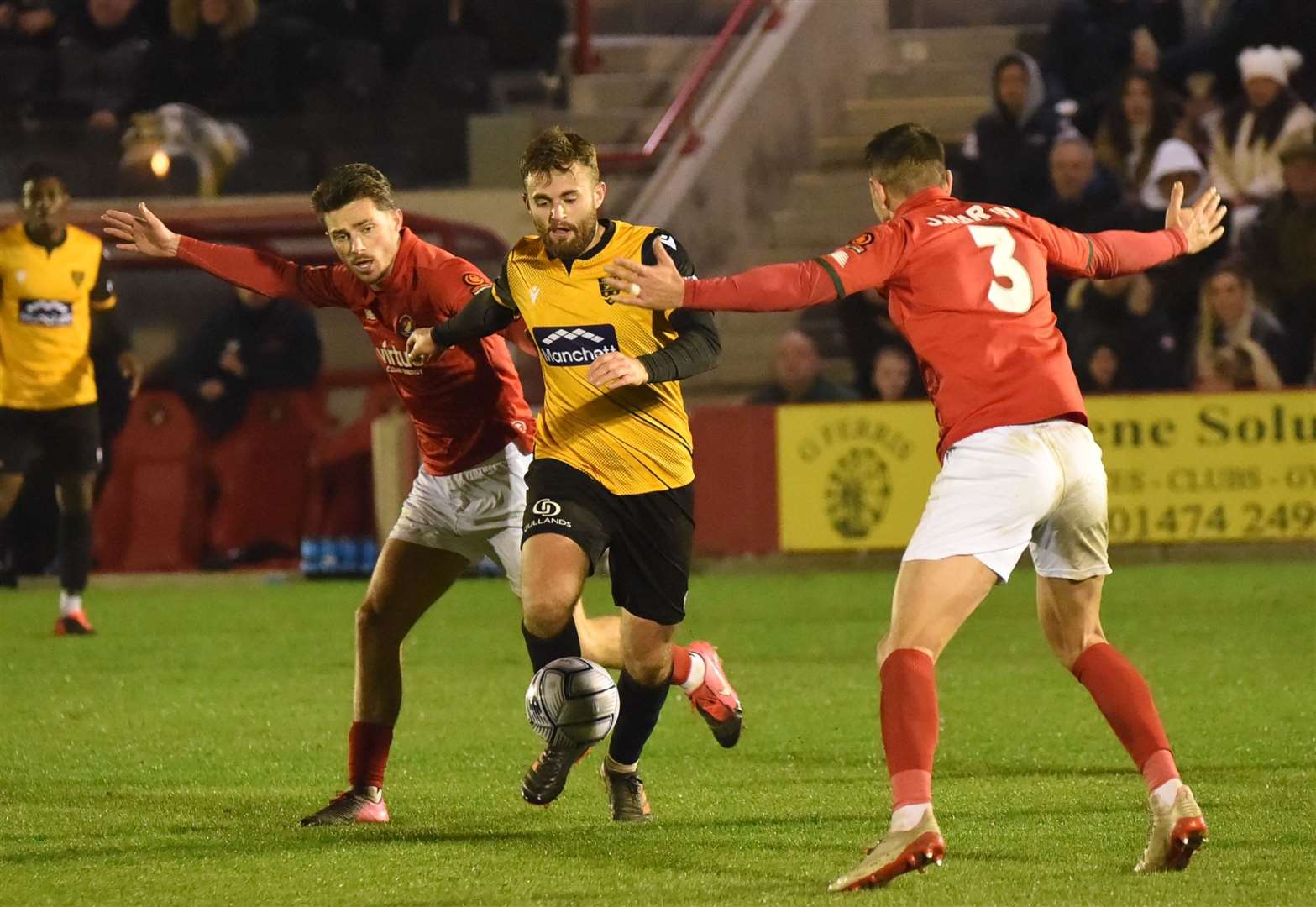 Maidstone midfielder Regan Booty is sandwiched by Jack Paxman and Joe Martin Picture: Steve Terrell