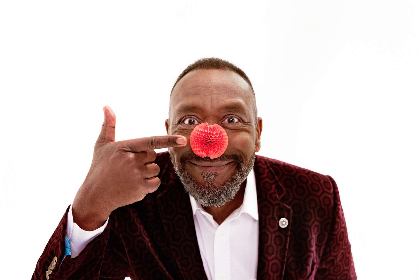 The new red nose, pictured here with Lenny Henry, has been designed by the man behind Apple's iPhone. Image: Comic Relief.