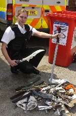 PC Janine Moon with some of the weapons handed into Tonbridge police station. Picture: JOHN WARDLEY