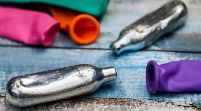 Cans of nitrous oxide, also known as laughing gas. Stock photo