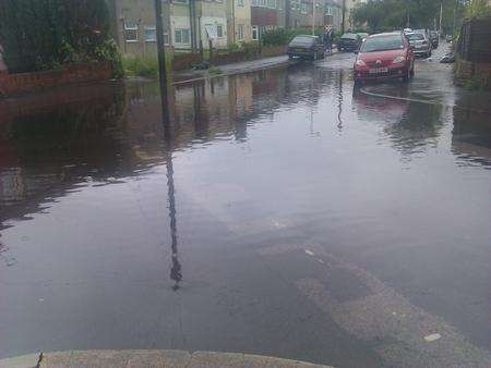 Heavy rain floods the junction of St Marks Avenue and Beresford Road, Northfleet