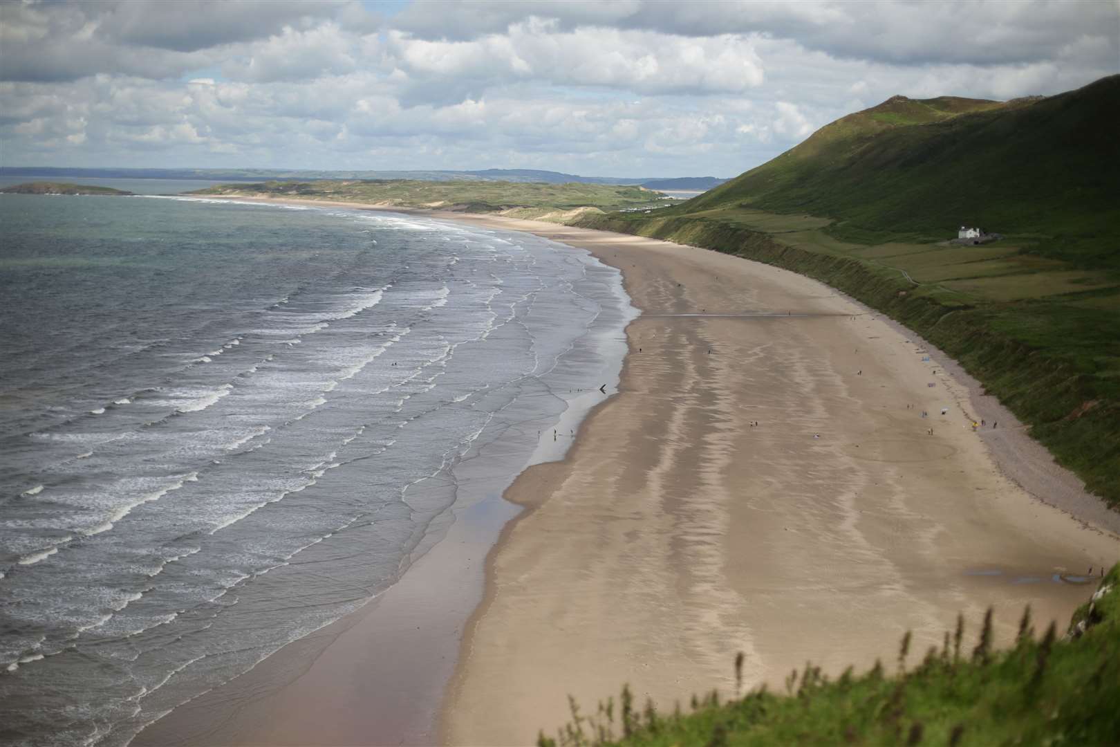 A view of the beach at Rhossili Bay (Yui Mok/PA)