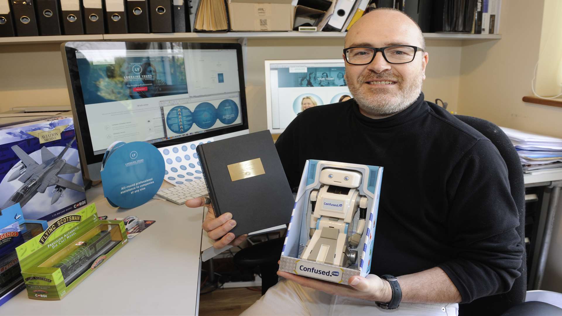 Drew Selman with the packaging he designed for Brian the robot