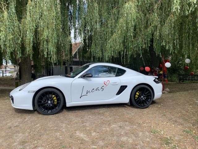 A white Porsche emblazoned with Lucas' name has been parked in front of his tree on Sandwich Quayside
