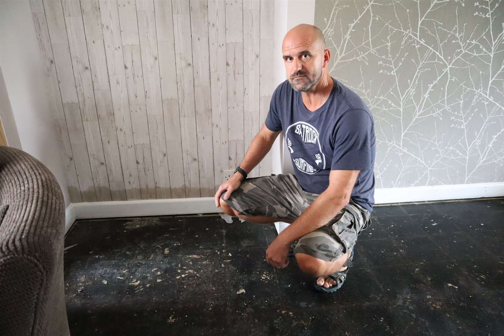 Steve England shows how far flood water reached his walls in Lansdown Road, Murston Picture: John Nurden