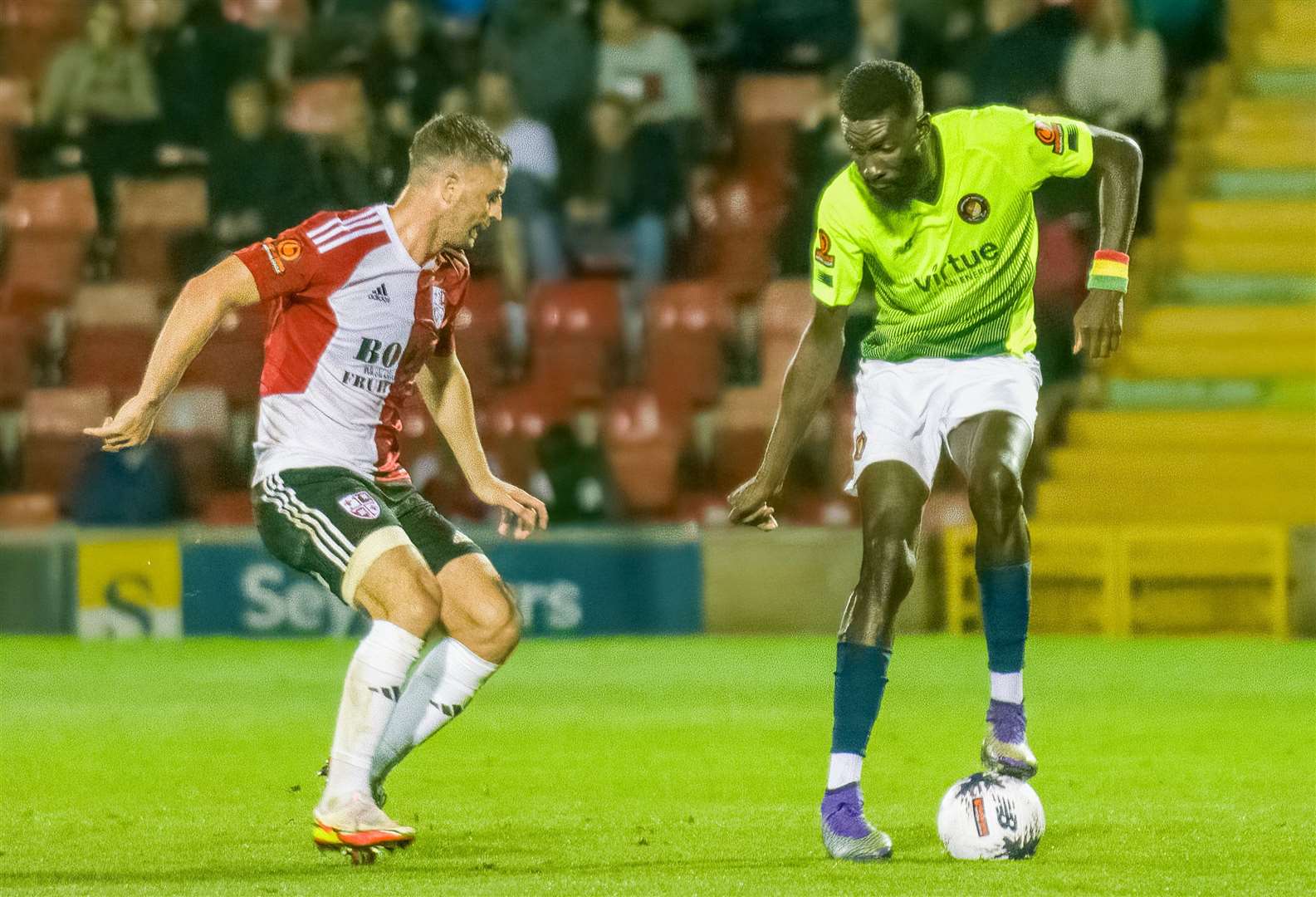Ebbsfleet's Ouss Cisse, right, battles for a point at Woking on Tuesday. Picture: Ed Miller/EUFC