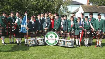 Anita Dobson, centre, with members of the Folkestone Pipe and Drum Band. Picture: MARTIN APPS