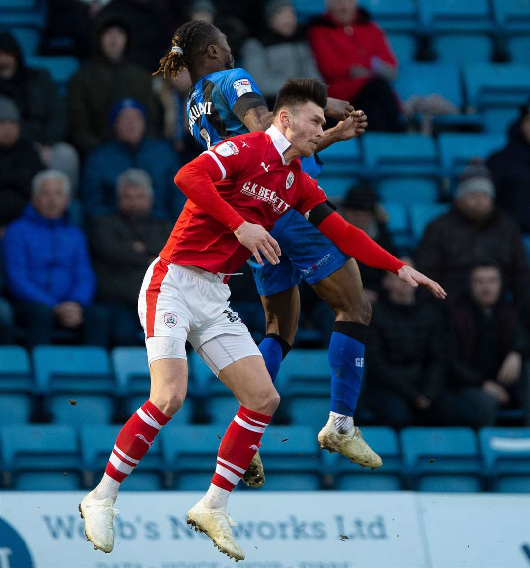 Gabriel Zakuani with his last challenge for the Gills, against Barnsley's Kieffer Moore, leaving both men injured long-term Picture: Ady Kerry