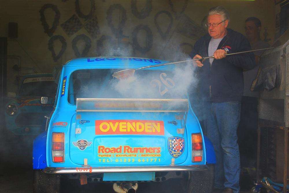 Richards holding the flour sieve as he directs the smoke bomb over the rear wing. Picture - Joe Wright