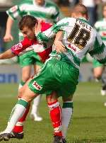 Jon Wallis tussles with Yeovil's David Poole. Picture: ANDY PAYTON
